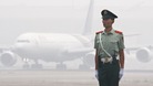 A Chinese paramilitary policeman on the tarmac at Beijing airport