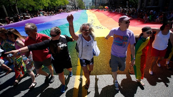 Gay rights supporters march with a rainbow flag during the gay pride parade in Salt Lake City earlier this month.