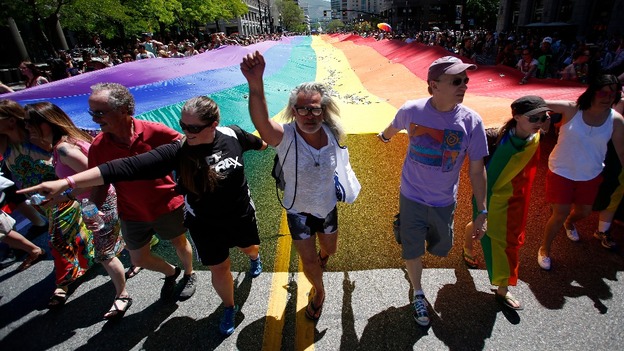 Gay rights supporters march with a rainbow flag during the gay pride parade in Salt Lake City earlier this month.