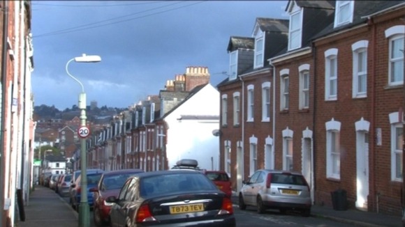 Modern street in Exeter with gap for bombed out house