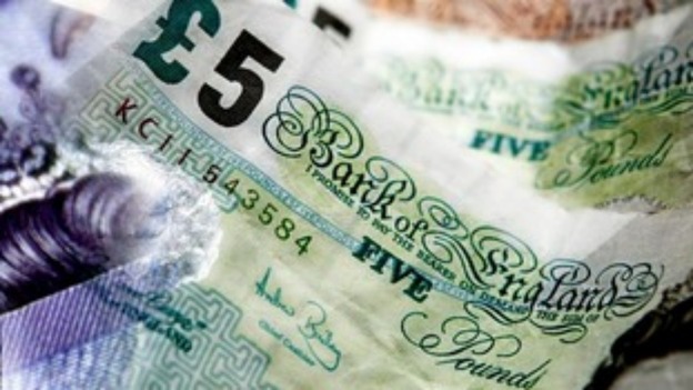 £5 notes in a pile.