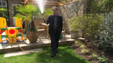 Tonight reporter Jonathan Maitland with a garden hosepipe