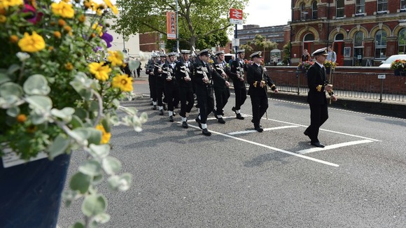Sailors march through the center of Portsmouth