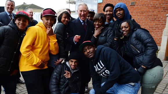 The Prince of Wales poses for photographs with local youths who take part in Prince's Trust activities