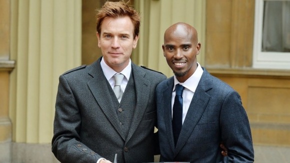 Ewan McGregor and Mo Farah show off their honours outside Buckingham Palace.