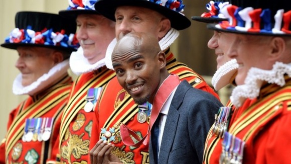 Mo Farah jokes around with Beefeaters after receiving his CBE.
