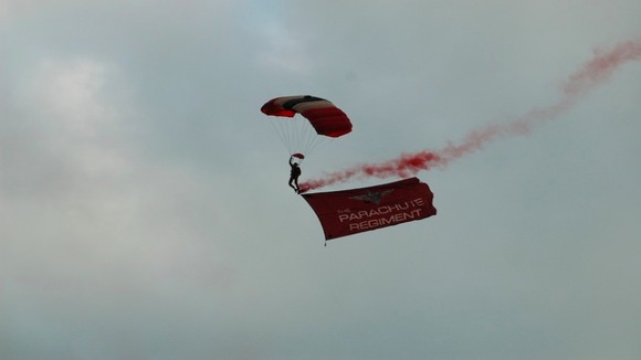 Hang glider from parachute regiment flying in against cloudy skies