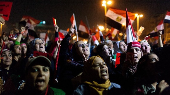 A large group of women take to the front of a gathering of opposition supporters in Cairo