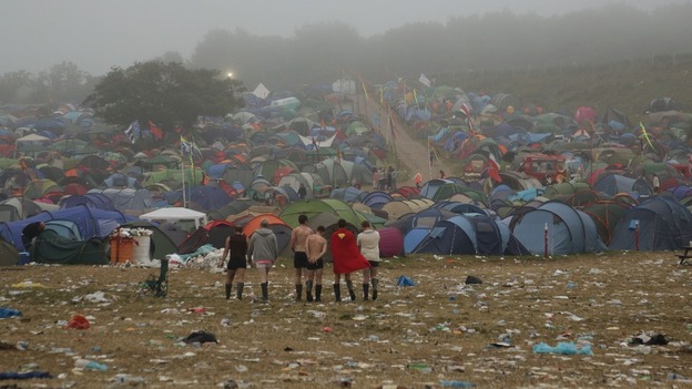 Festival goers survey the camp site at Worthy Farm