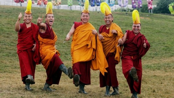 The Gyuto Monks of Tibet pose with wellies at Glastonbury
