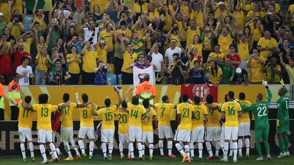 Brazil wave to the crowd after their victory over Spain