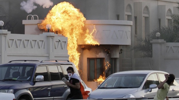 Bahraini anti-government protesters throw petrol bombs at a police station