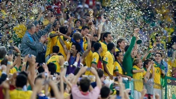 Brazil's players celebrate on the podium with the trophy
