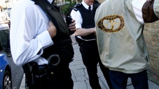 Police stop and search a man in Brixton, south London.