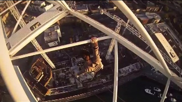 James Kingston hanging from a crane