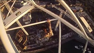 James Kingston hanging from a crane