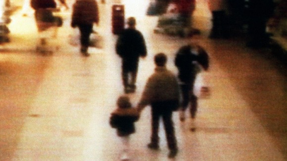 James Bulger seen in 1993 being led away at a shopping centre in the Bootle area of Liverpool