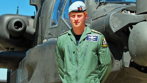 Prince Harry by an Apache attack helicopter