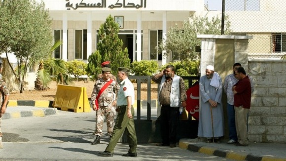 Family members of radical Muslim cleric Abu Qatada stand near the State Security Court in Amman.
