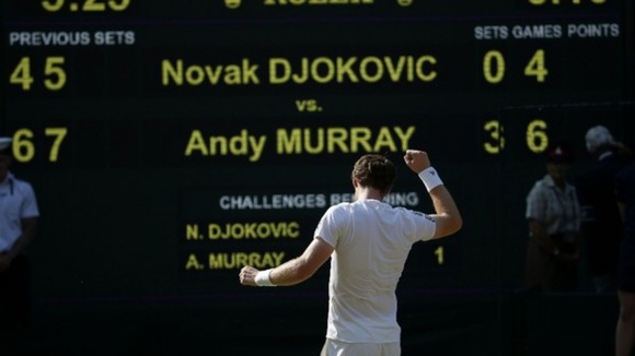 Andy Murray in front of the score board after defeating Serbia's Novak Djokovic