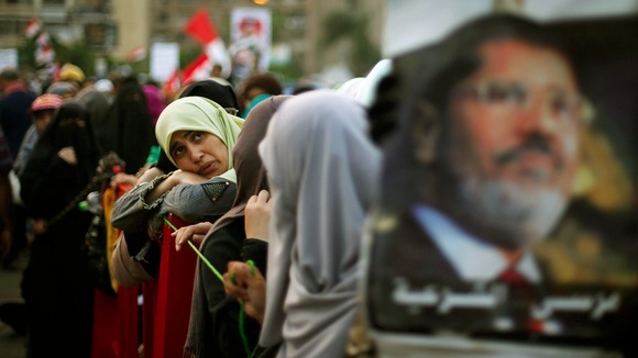 Morsi supporter attends a protest outside Rabaa Adawiya mosque