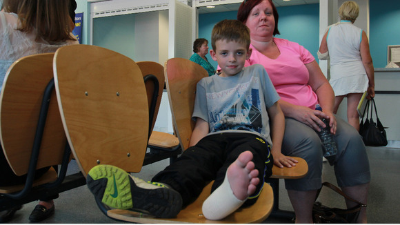 Ryan and his mother Alison waiting to be seen in the mior injuries clinic.