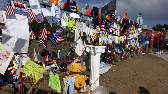 A fence in Prescott, Arizona has become a virtual shrine to the firefighters with hundreds of mementos left