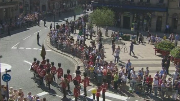 The crowds clap as the procession to Bury Parish Church begins.
