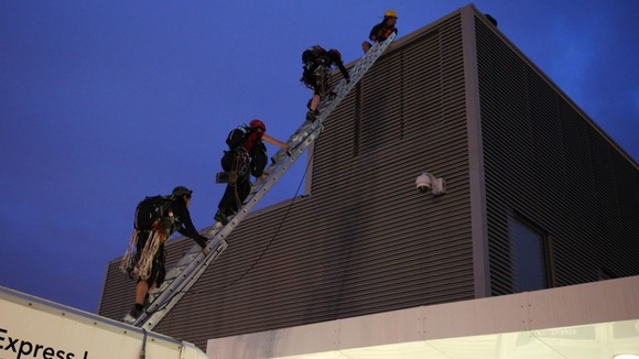 The protesters emerging from the roof of a lorry at the base of The Shard this morning