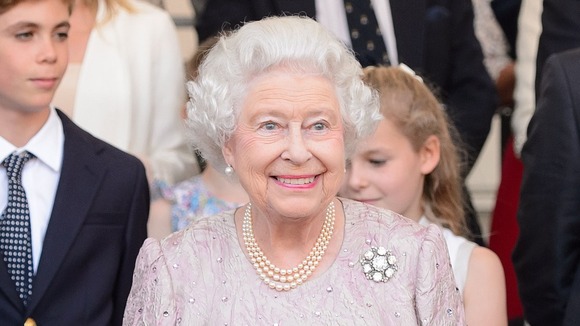 The Queen watches the proceedings at Buckingham Palace