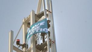 A Greenpeace activist unveils a Save The Arctic flag on top of the Shard Building