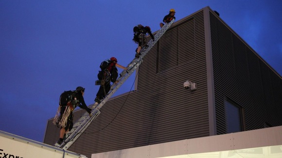 The ascent began this morning with the protesters climbing out of the roof of a parked lorry