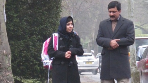 Malala with her father Ziauddin on her first day of school in the UK