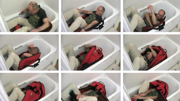 Images issued by the Metropolitan Police of a video reconstruction showing an "expert" trying to lock himself in a sports bag unaided.