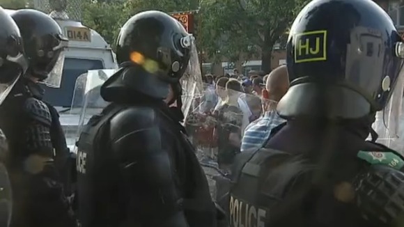 Police with riot shields in Belfast on Friday night.