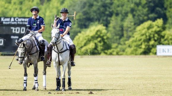 The Duke of Cambridge (right) enjoys a joke with his team-mate.