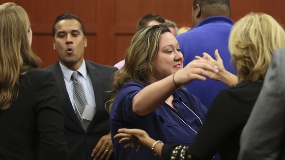George Zimmerman's wife, Shellie (centre), celebrates with family and friends following her husband's not guilty verdict.