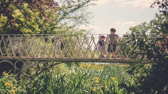 two children on bridge in sun at Spetchley Park and gardens in Worcester