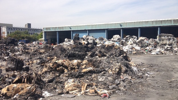 The warehouse in the background was saved from the flames