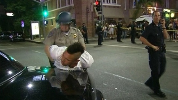 A man is arrested during the protests