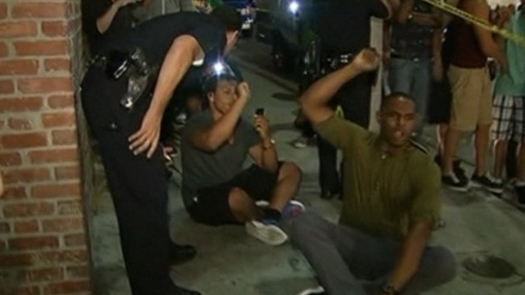 Police officers attempt to move protesters during a sit-in