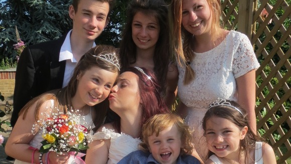 Paula surrounded by her six children