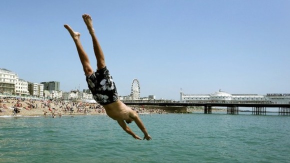 Andrew Smith leaps off the sea wall in Brighton, East Sussex.