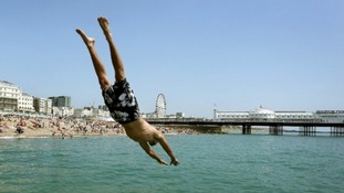 Andrew Smith leaps off the sea wall in Brighton, East Sussex.