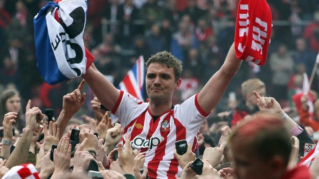 Southampton's Jos Hooiveld is carried off the pitch by fans at the end of the game after the club's promotion to Premier League