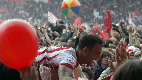 Southampton's Daniel Fox is carried off the pitch by jubilant fans at the end of the game