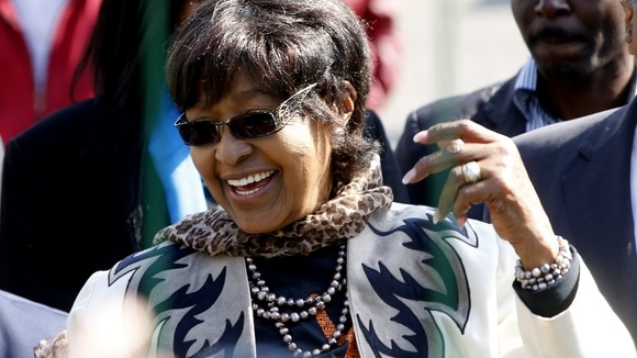 Winnie Madikizela-Mandela greeting wellwishers gathered outside her former husband's hospital.