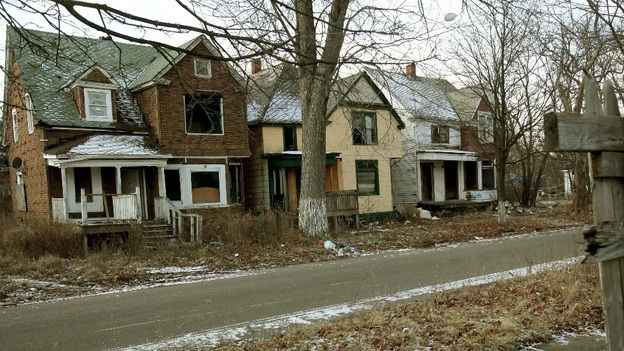 A row of vacant boarded up houses in a once vibrant east side neighbourhood of Detroit, Michigan.