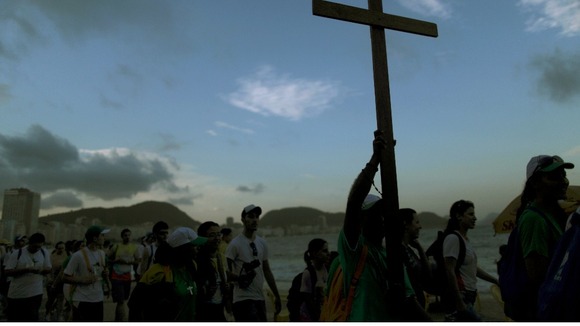 Youths carry a cross on Copacabana beach ahead of World Youth Day in Rio de Janeiro.