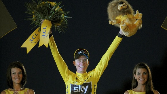 Chris Froome takes to the podium after winning the Tour de France.